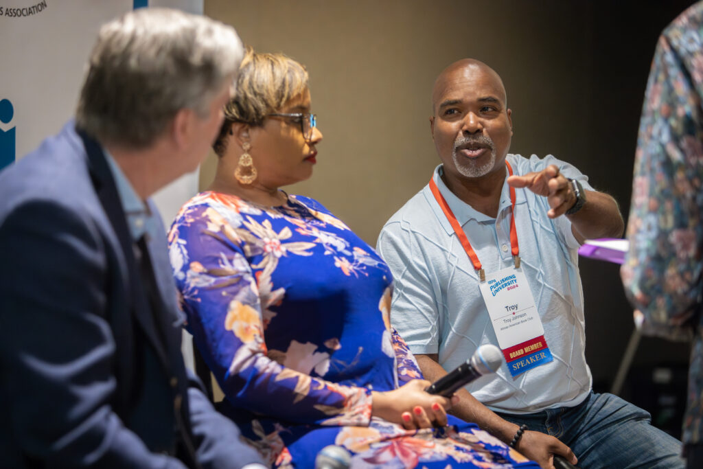 Event Management Success: How The Independent Book Publishers Association Amplifies Marginalized Voices 2 Attendees Talking At Ibpa Event Management Conference